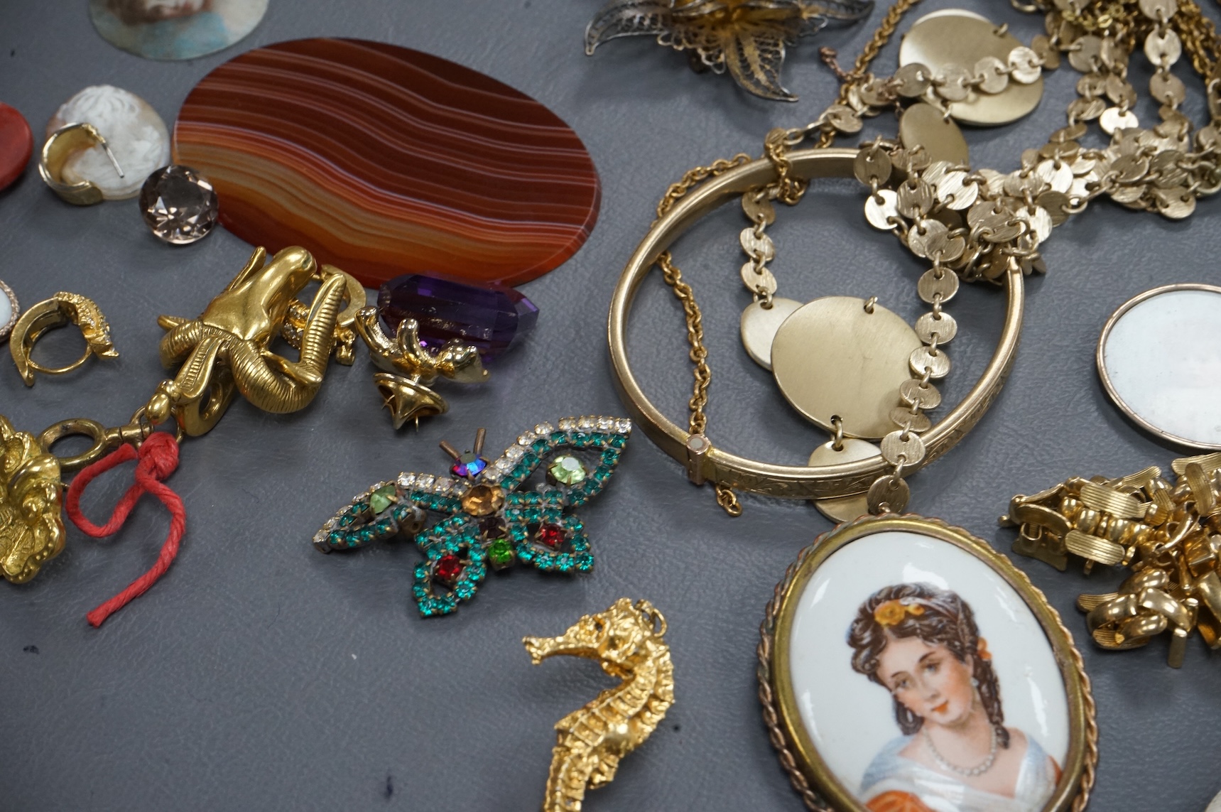 A quantity of assorted costume jewellery and other items including wrist watches, watch movements and a silver vesta case.